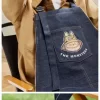 SÉRIE LES MONSTRES TOMBERENT À L&rsquo;ÉTAT SAUVAGE – Sac tablier en jean